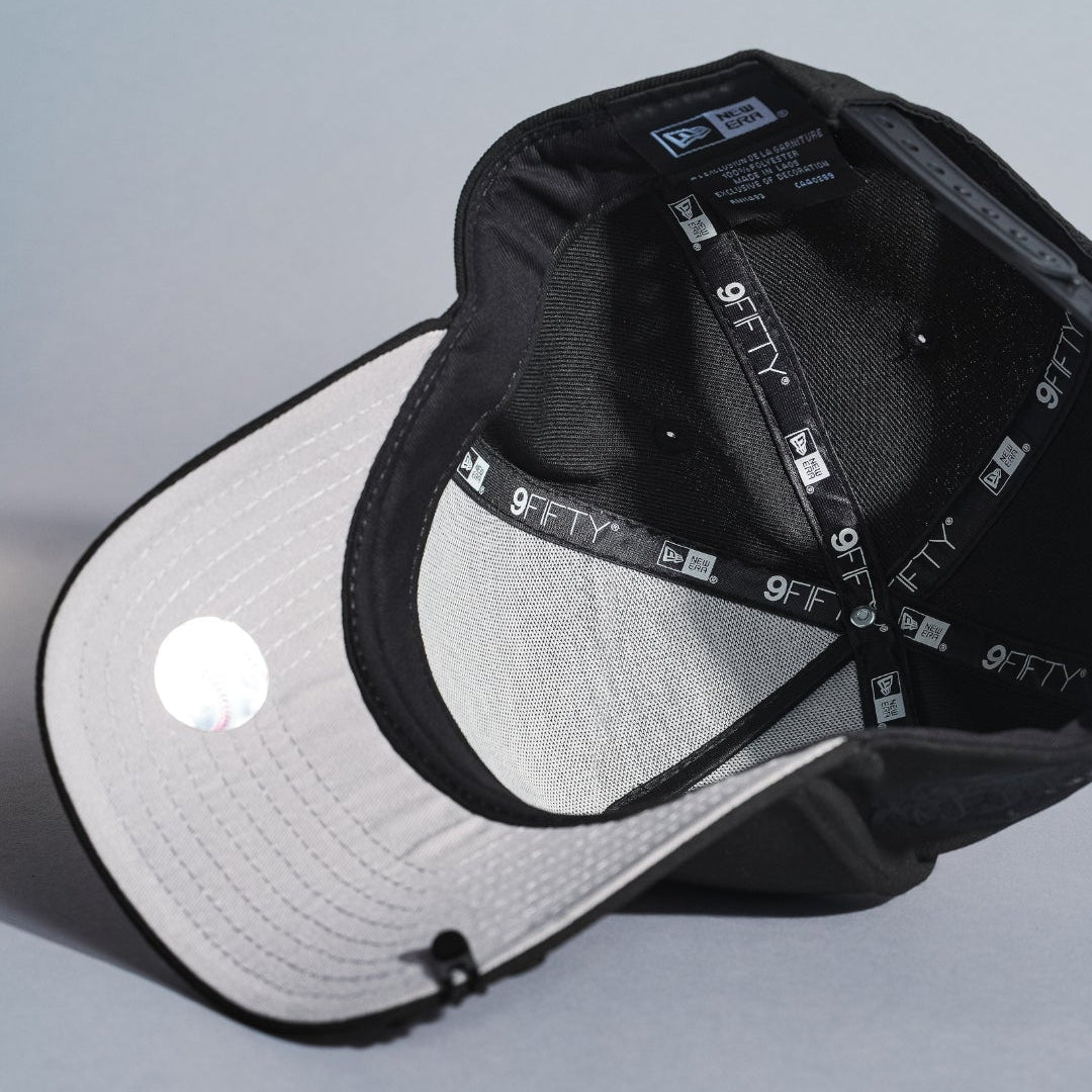 NEW ERA 9FIFTY A-FRAME BLACKED OUT NEW YORK YANKEES SNAPBACK W/ 1999 WORLD SERIES SIDE PATCH