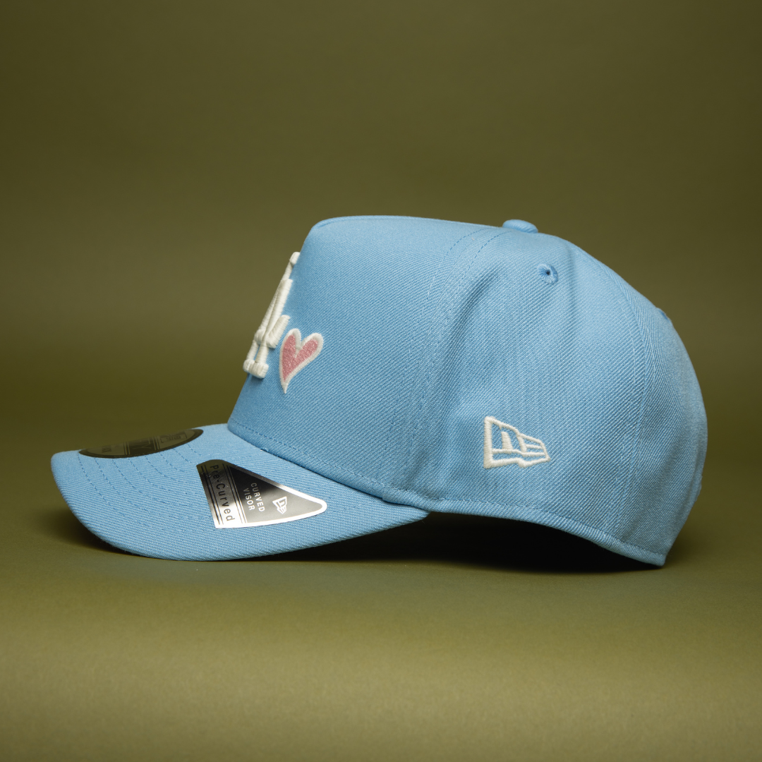 NEW ERA 9FIFTY A-FRAME ICY BLUE LOS ANGELES DODGERS SNAPBACK W/ PINK HEART + 60TH ANNIVERSARY SIDE PATCH