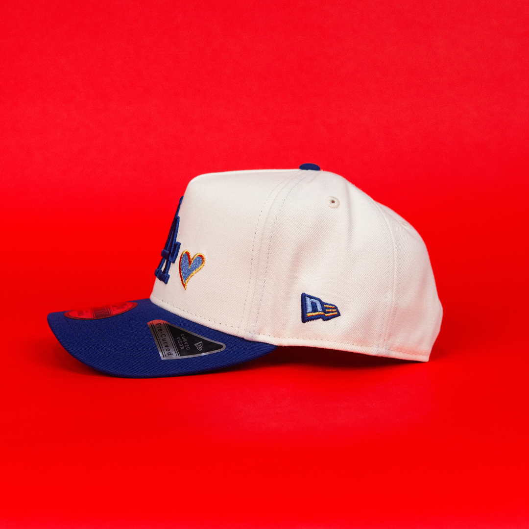 NEW ERA 9FIFTY A-FRAME CHROME/ BLUE LOS ANGELES DODGERS SNAPBACK W/ BLUE HEART + 50TH ANNIVERSARY SIDE PATCH