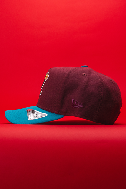 NEW ERA 9FIFTY A-FRAME BURGUNDY/TURQUOISE ANAHEIM DUCKS SNAPBACK W/ "DUCKS" SIDE PATCH