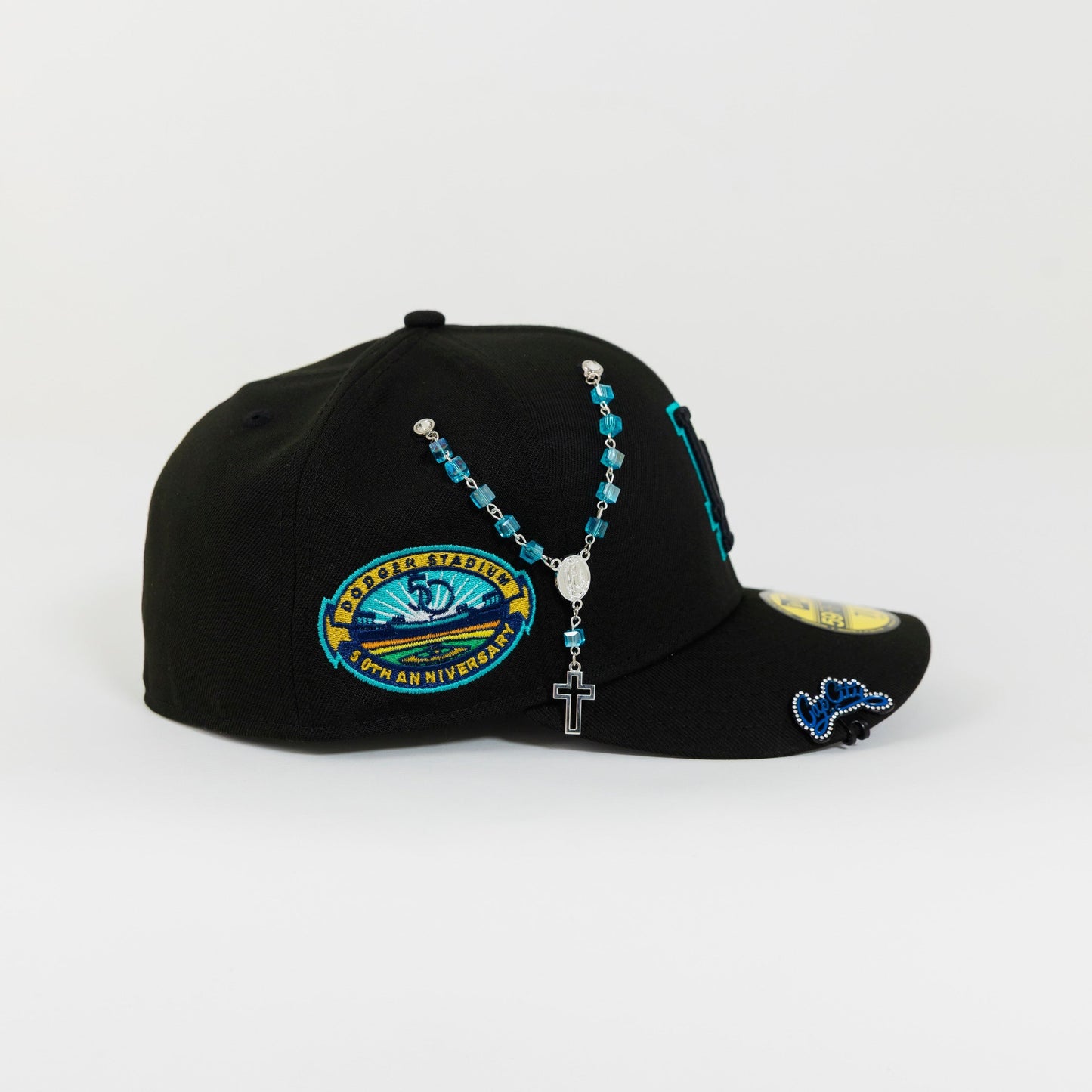 NEW ERA 59FIFTY BLACKED OUT LOS ANGELES DODGERS W/ TEAL OUTLINE + 50TH ANNIVERSARY SIDE PATCH