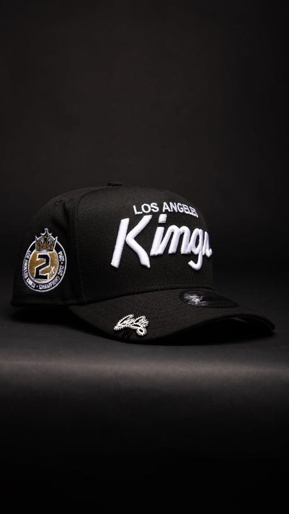 NEW ERA 9FIFTY A-FRAME BLACK LOS ANGELES KINGS SCRIPT SNAPBACK W/ 2012 NHL CHAMPIONS SIDE PATCH