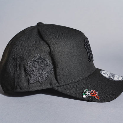 NEW ERA 9FIFTY A-FRAME BLACKED OUT NEW YORK YANKEES SNAPBACK W/ 1999 WORLD SERIES SIDE PATCH