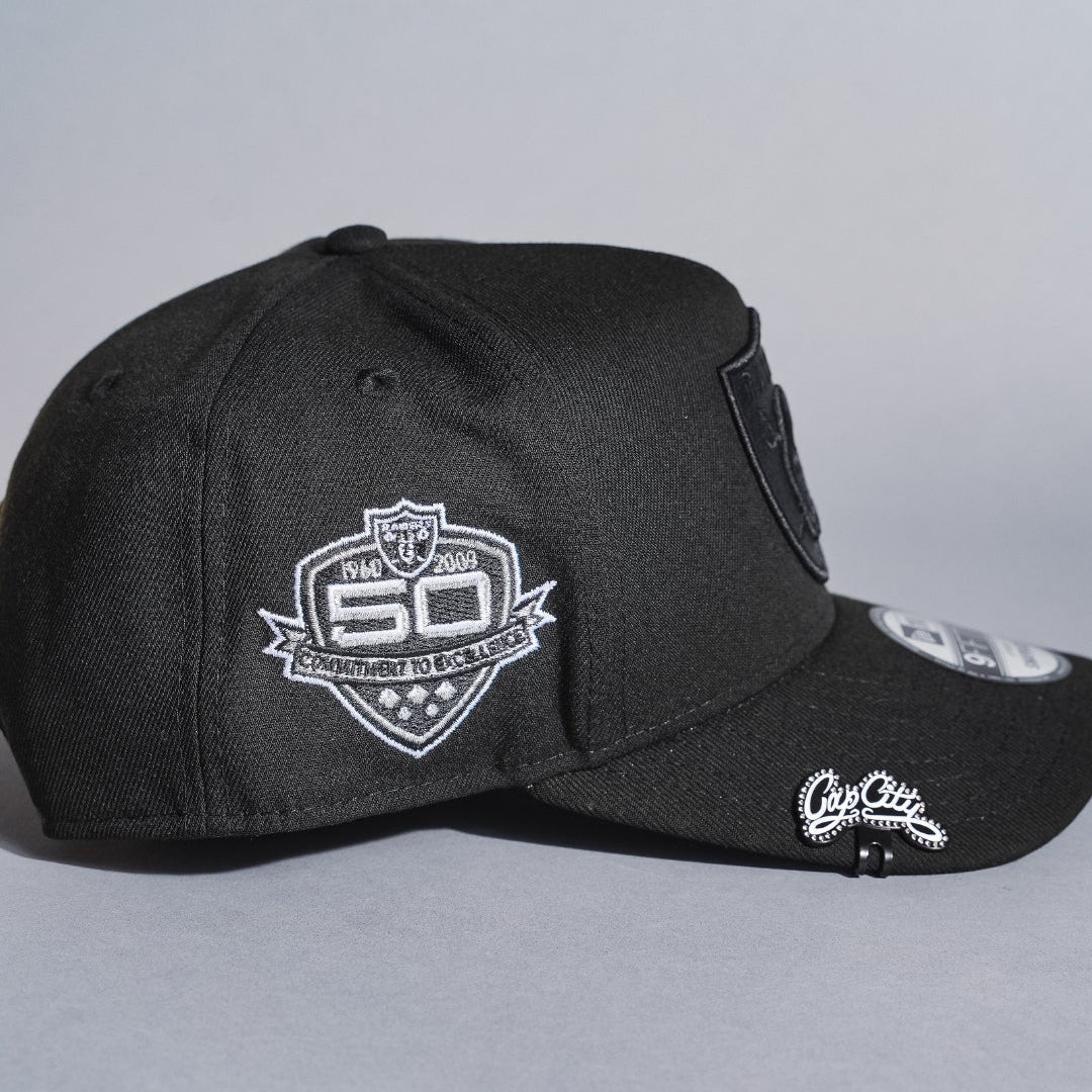 NEW ERA 9FIFTY A-FRAME BLACKED OUT LAS VEGAS RAIDERS SNAPBACK W/ 50TH ANNIVERSARY SIDE PATCH