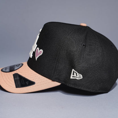 NEW ERA 9FIFTY A-FRAME BLACK/KHAKI LOS ANGELES DODGERS SNAPBACK W/ PINK HEART + 50TH ANNIVERSARY SIDE PATCH