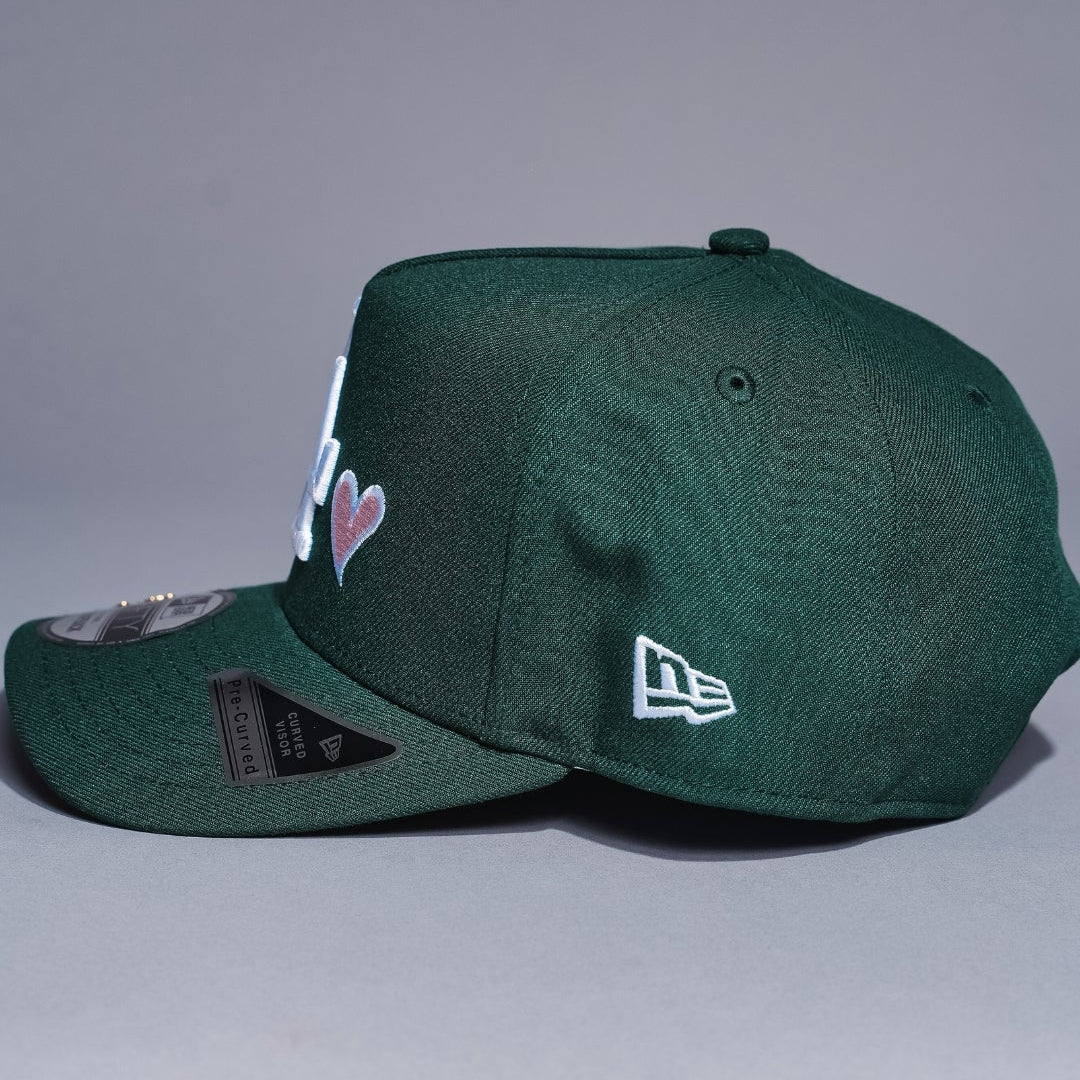 NEW ERA 9FIFTY A-FRAME FOREST GREEN LOS ANGELES DODGERS SNAPBACK W/ HEART + WORLD SERIES CHAMPIONS SIDE PATCH