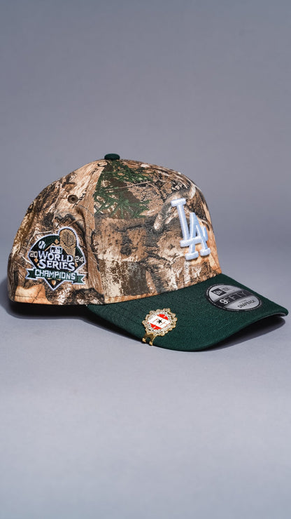 NEW ERA 9FIFTY A-FRAME REALTREE/GREEN LOS ANGELES DODGERS SNAPBACK W/ WORLD SERIES CHAMPIONS SIDE PATCH