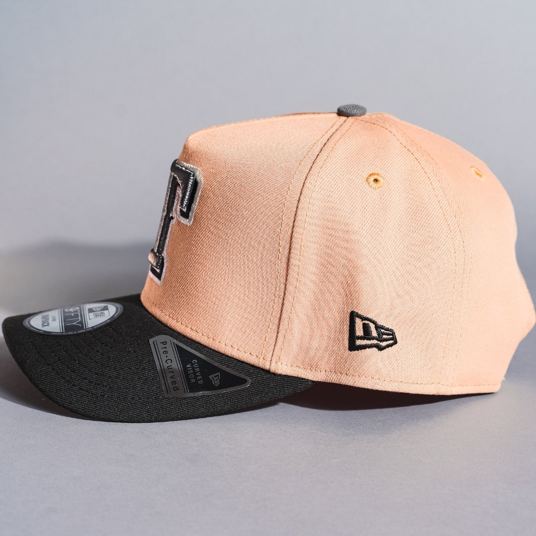 NEW ERA 9FIFTY A-FRAME BLUSH/BLACK TEXAS RANGERS SNAPBACK W/ WORLD SERIES CHAMPIONS SIDE PATCH