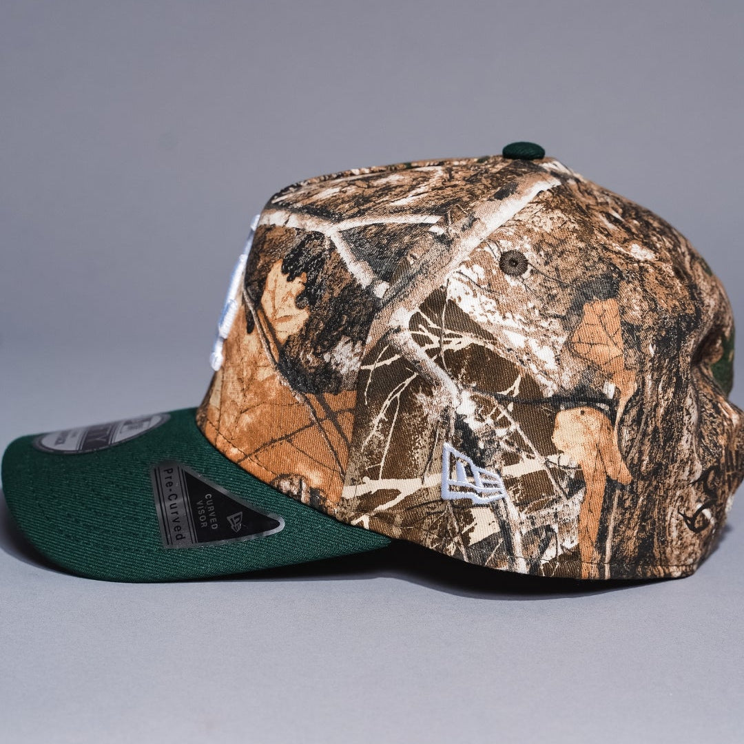 NEW ERA 9FIFTY A-FRAME REALTREE/GREEN LOS ANGELES DODGERS SNAPBACK W/ WORLD SERIES CHAMPIONS SIDE PATCH